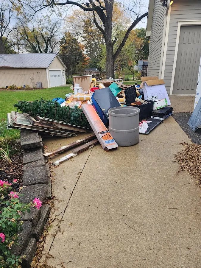 Dumpster being loaded with debris for Roofing Dumpster Rental in DuPont